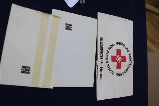 A German Red Cross armband and paperwork, a mothers cross, a general assault badge